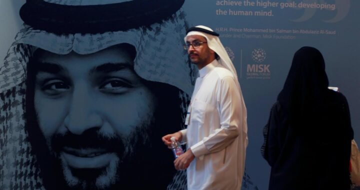A file photo shows a participant walking next to a picture of Saudi Crown Prince Mohammed bin Salman during the Misk Global Forum in Riyadh, 14 November 2018