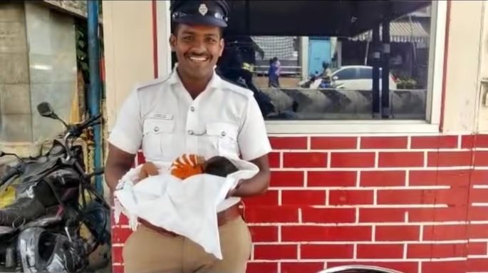 Traffic cop goes beyond duty, takes care of infant while mother ate lunch